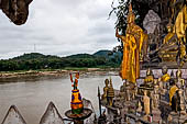 Luang Prabang, Laos - The Pak Ou Caves, the lower cave called Tham Ting. The caves, a Buddhist pilgrimage site, are a repository of old Buddha statues.